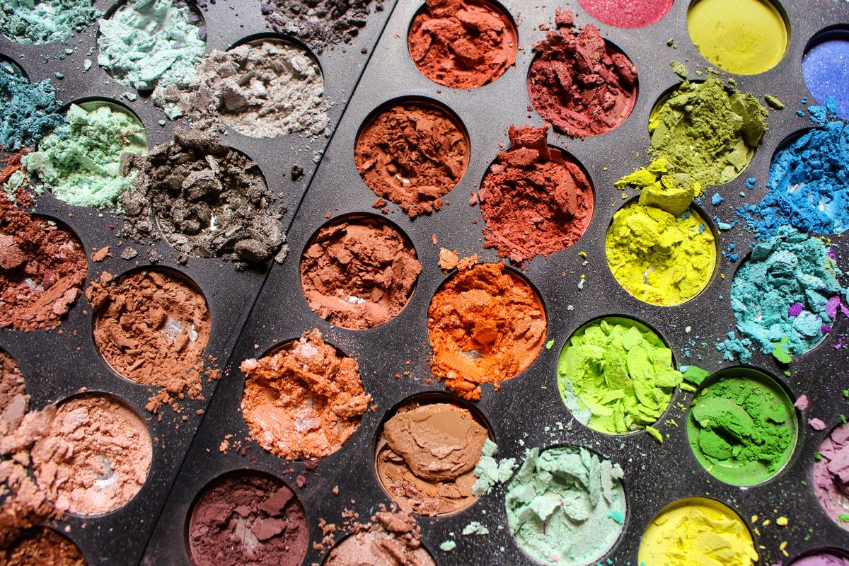 A palette of pressed powder products in warm tones